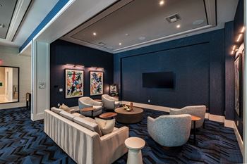 A modern living room with a large couch and a television.